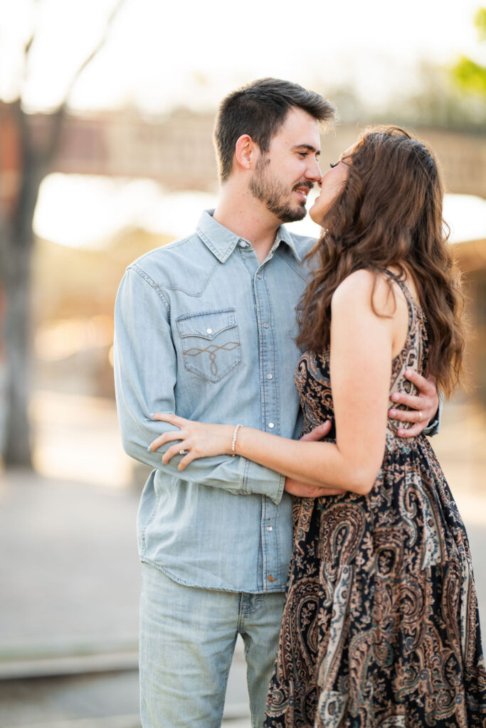 Couple sharing a quiet romantic moment during a sunrise session at the Fort Worth Stockyards