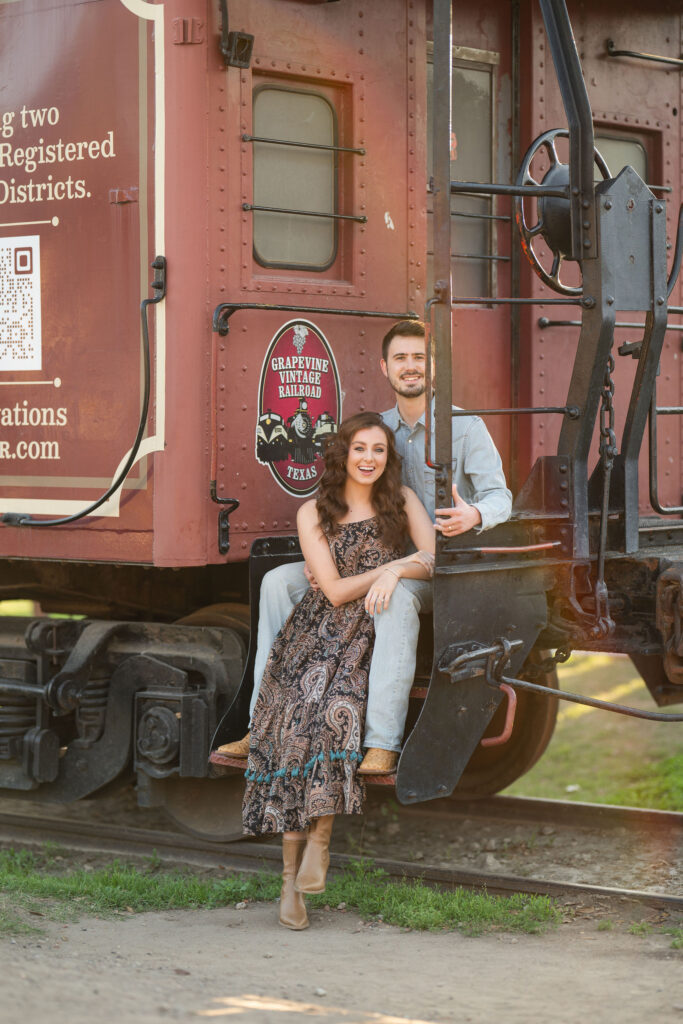 Couple seated on the steps of a Grapevine Vintage Railroad car in the Fort Worth Stockyards