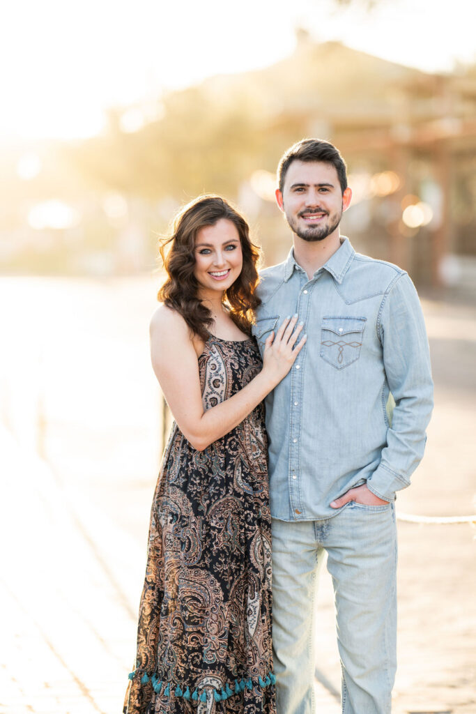 Couple posing in golden sunrise light during a Fort Worth Stockyards photoshoot