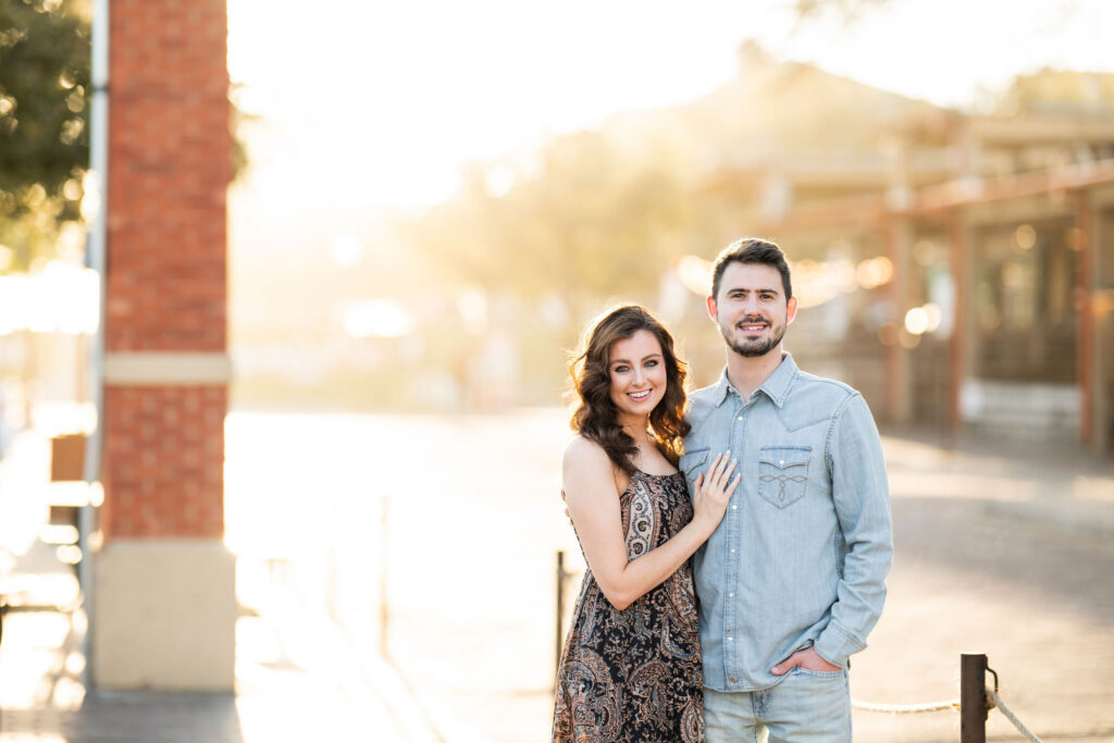 Couple posing during a sunrise photo session at the Fort Worth Stockyards