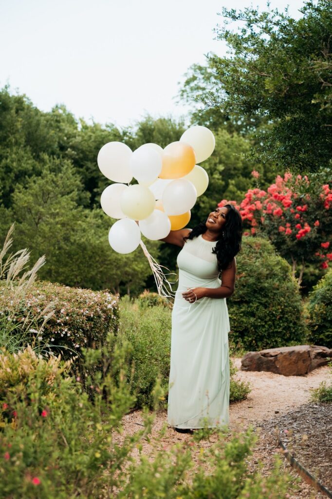 Woman celebrating her birthday along a garden pathway at Keller Pointe