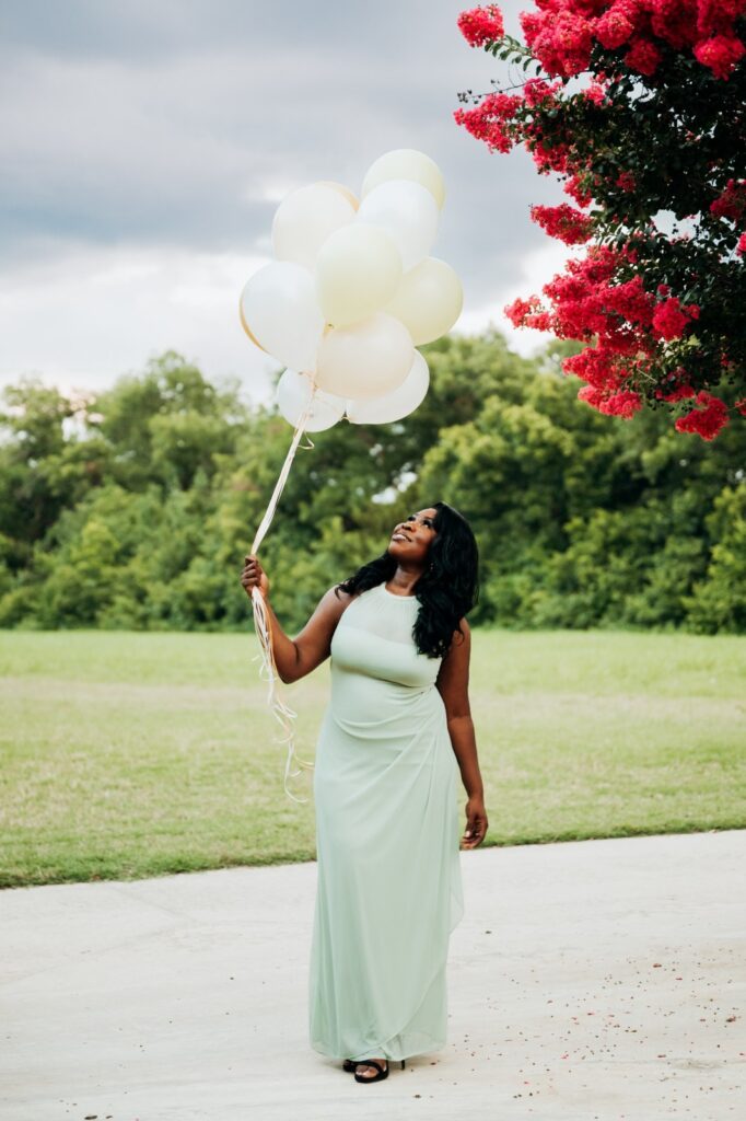 Birthday photoshoot beneath pink flowers at Keller Pointe in Texas